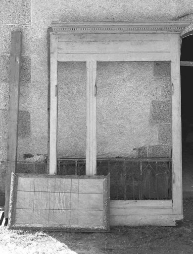 Ensemble d'éléments de mobilier religieux déposés dans l'abattoir (lambris de revêtement avec corniche ornée d'une frise denticulée, devant d'autel en bois avec cadre rapporté, orné d'un décor sculpté dans la masse, clôture de choeur en fer forgé).