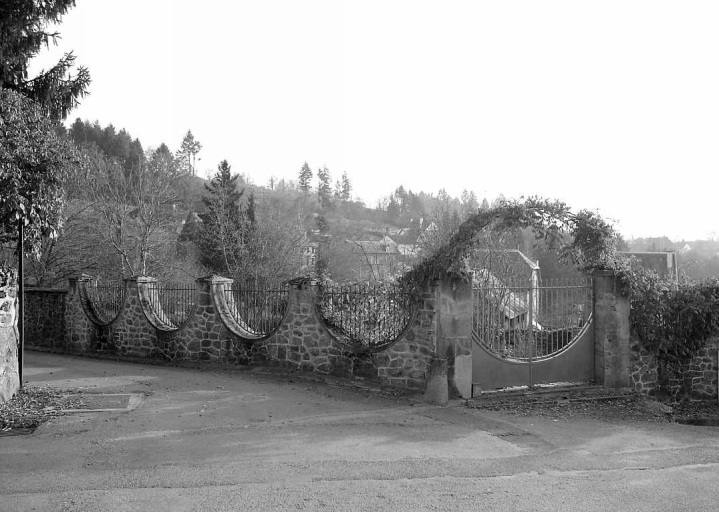 Rue de Beaumont. Vue de la grille de clôture et du portail d'un jardin réalisés dans le style des années 1930.