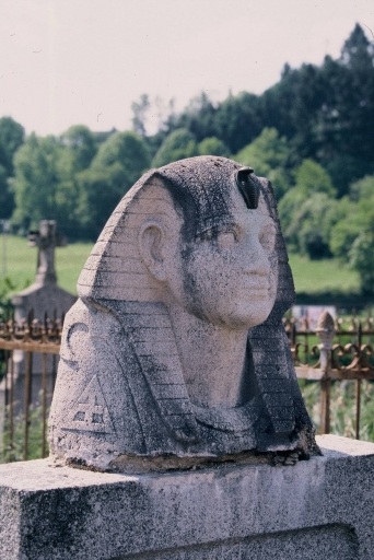 Tête d'égyptien ornant une tombe. Vue prise de trois-quarts. Cette sculpture n'est plus visible aujourd'hui.