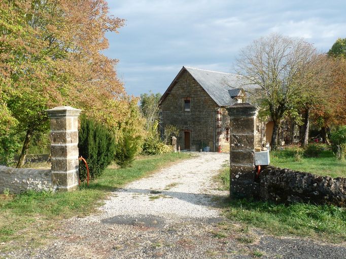 Entrée de la ferme au 19e siècle marquée par deux piliers de section carrée.