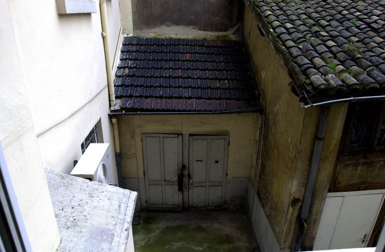 Vue des petites dépendances (WC ?) construites dans la cour, depuis l'escalier de l'immeuble