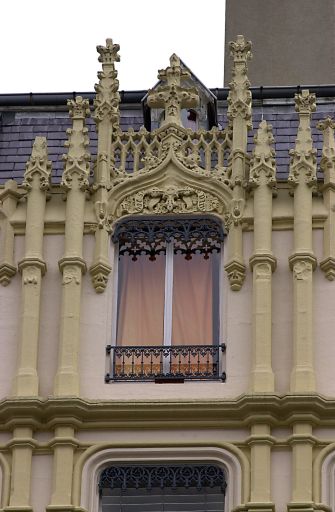 Façade principale sur la rue Chavanne, détail de la baie axiale du dernier étage.