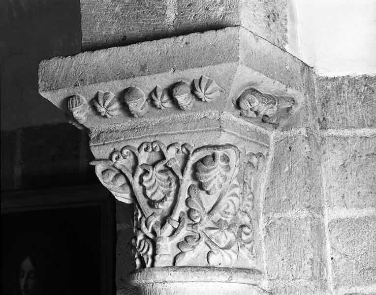 Entrée de l'abside, côté nord, chapiteau : corbeil à décor de palmettes, tailloir à guirlande de têtes et de cabochons.