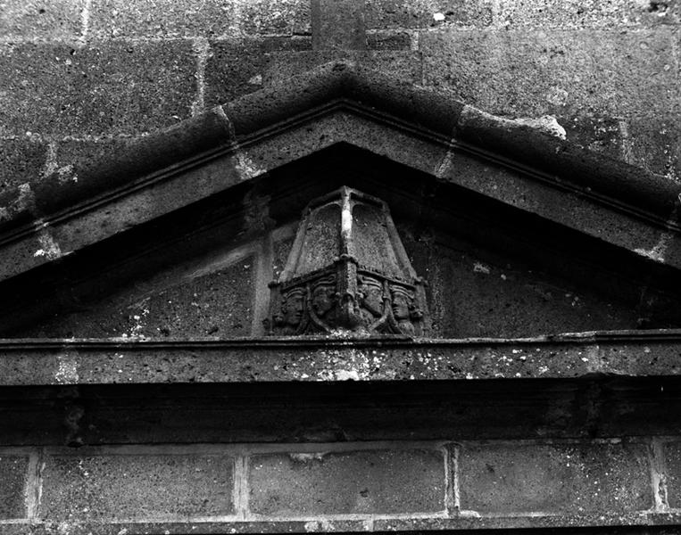 Détail d'une pierre sculptée, en remploi sur le fronton du portail d'entrée.