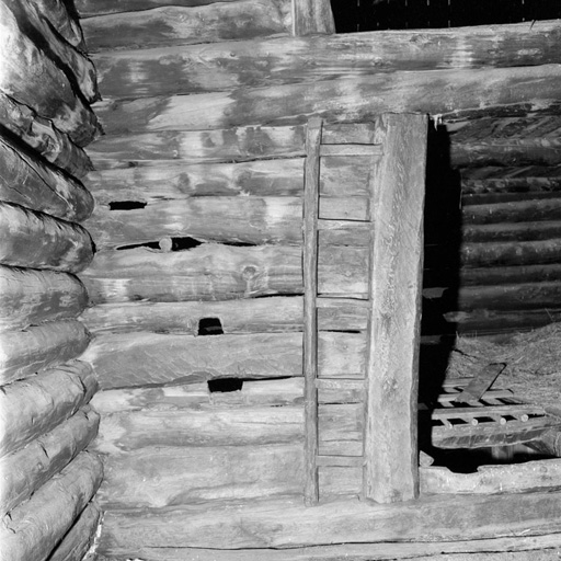 La grange, niveau supérieur. Vue intérieure : l'échelle encastrée dans le montant de l'ouverture.