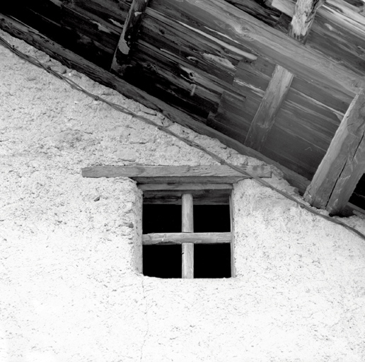Le Rosier. Ferme  parcelle 239. Façade sud sur la cour. Fenestron à grille de bois scellée dans le tableau.