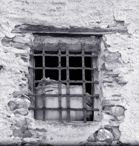 Maison 717. Façade ouest, troisième niveau. Grille de fenêtre rivetée (quatre feuilles). ; L'Envers du Fontenil. Parcelle 717. Façade ouest. Troisième niveau. Grille de fenêtre rivetée (quatre feuilles).