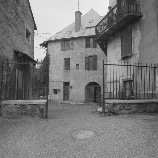 Chef-lieu. Parcelles 452 et 456. Vue d'ensemble prise de l'est. A droite, façade peinte. A gauche, imposte en fer forgé datée de 1778.