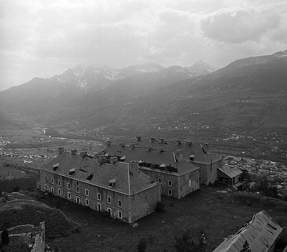 Enceinte basse. De gauche à droite : les bâtiments E, D et C avec, accolé à ce dernier, le bâtiment a (recette du téléphérique). En bas et à droite, la toiture du bâtiment M1.