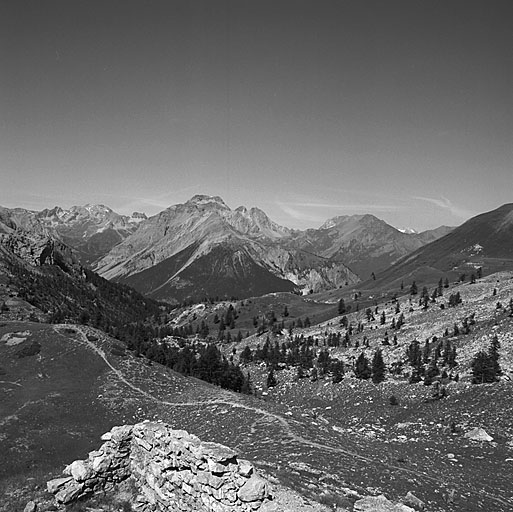 Vue prise de la crête du versant italien du col. Au premier plan, le vallon Guiau, descendant vers le Mélézet. Au fond, la Pointe des Quatre-Soeurs.