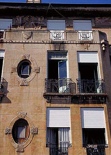 Vue partielle de la partie supérieure de la façade est percée d'oculi et ornée de balconnets, depuis l'est.