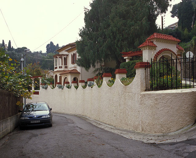 Vue d'ensemble depuis le nord avec portail au premier plan de la Villa Les Palmiers.