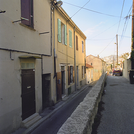 Rue. Vue générale de l'alignement des maisons coté impair (îlot sud), prise depuis le presbytère.