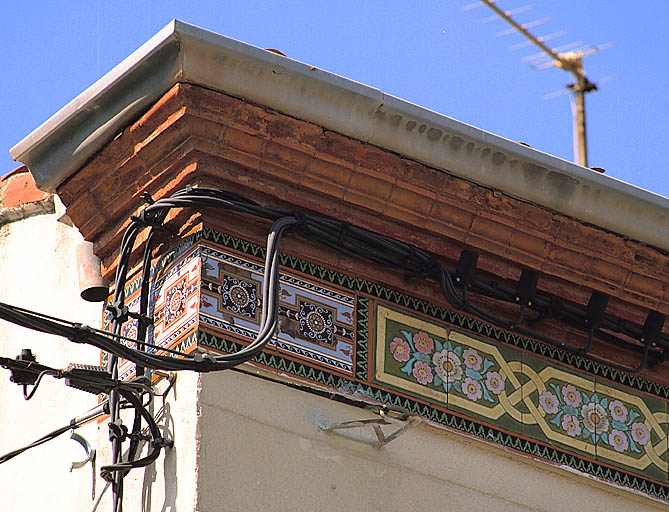 Fig. 19 - Maison, 41 rue Le-Pelletier (parcelle H 269), construite en 1892 pour Jean Fonderey, tuilier. Détail de la corniche en briques moulurées et de la frise en carreaux de céramique, pris sur l'angle est.