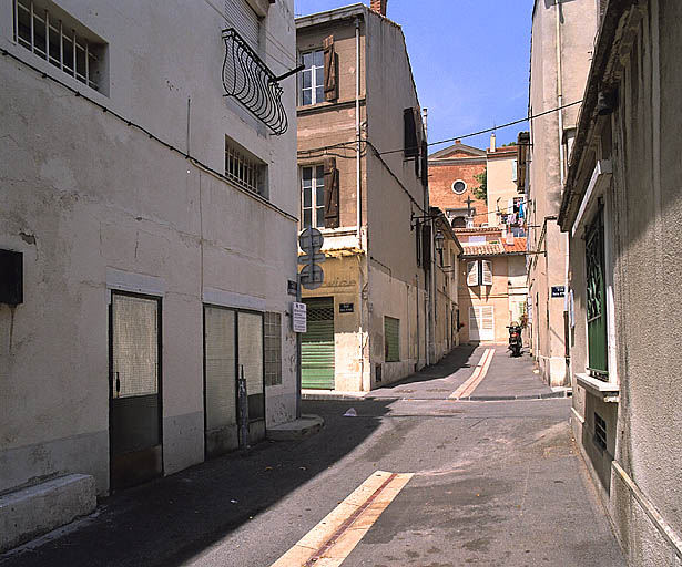 Vue en perspective sud-nord de la rue des Scaphandriers, prise depuis la voie de la Plage. Au deuxième plan, le carrefour avec la rue Martial-Reynaud. A l'arrière-plan, en contre-haut, la façade de l'église.