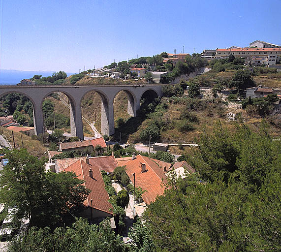 Vue plongeante sur la courée, prise depuis le viaduc de la cimenterie. A l'arrière-plan, le viaduc des Riaux.