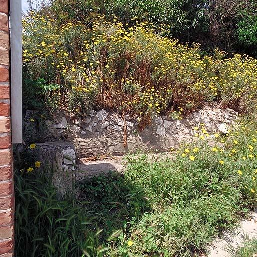 Vestige d'un banc en rocaille, à l'entrée de la propriété.