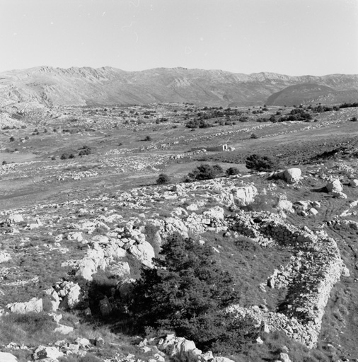 Partie orientale du Plateau de Calern vue vers le nord-est : au premier plan un petit enclos rectangulaire, au second plan les lieux-dits Les Poumeirès (au centre), Vaumeillane (à gauche) et La Clapoua (au centre en haut), en arrière plan la montagne du Cheiron (à gauche) et son prolongement vers l'est.