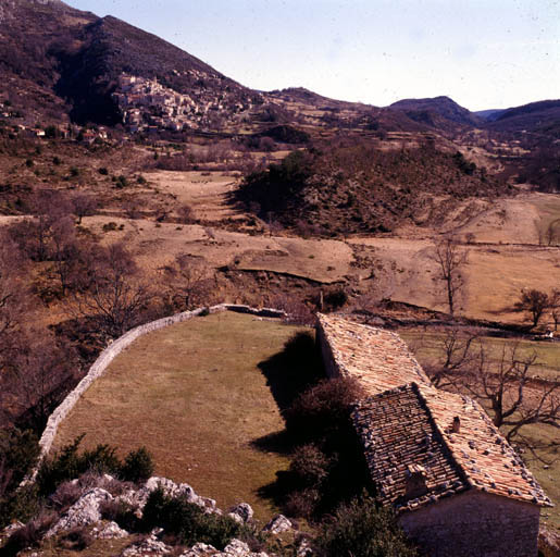 Vue de situation des éléments les plus anciens (logements, bergerie est et aire) en bout de l'éperon, depuis l'ouest. ; Coursegoules.  L'Autreville. Ferme. Vue de situation des éléments les plus anciens (logements, bergerie est et aire) en bout de l'éperon, depuis l'ouest.