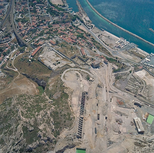 Vue aérienne prise de l'ouest. Au premier plan, le site des usines démolies, au second plan, l'agglomération des Riaux et la mer.