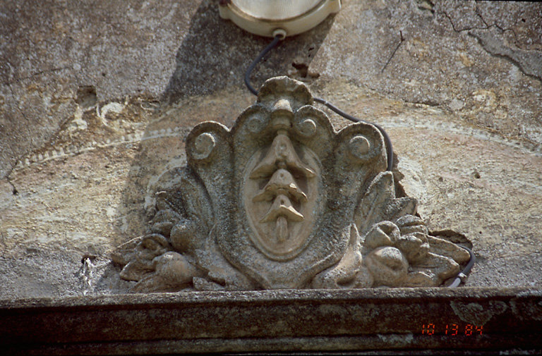 Eglise : cartouche sommant la porte.