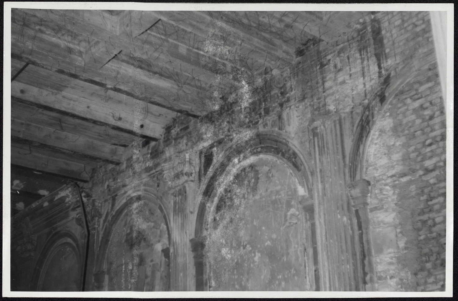 Vue de détail des dommages de guerre sur le plafond et les murs de la grande salle à manger.