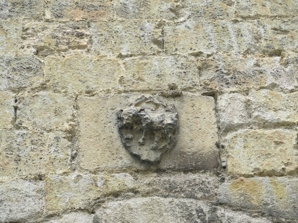 Mur sud. Ecu sculpté d'un animal, au sommet d'un arc brisé.