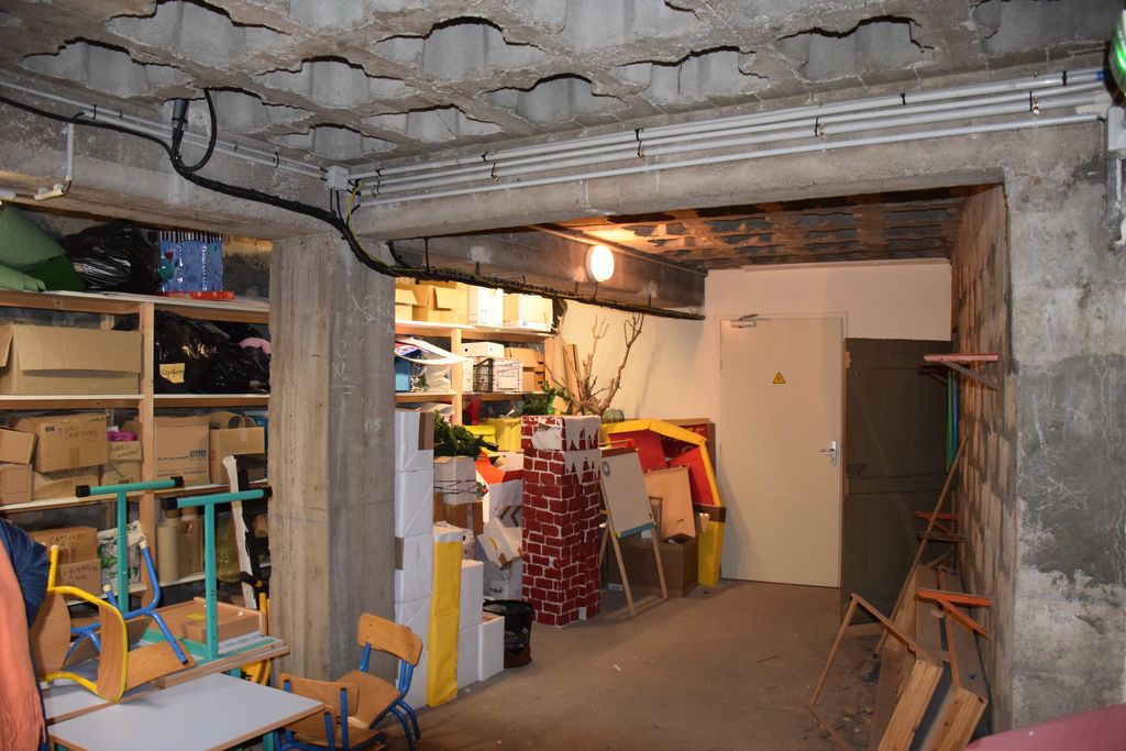 Ecole maternelle. Sous-sol. Piliers et  plafond alvéolé en béton armé.