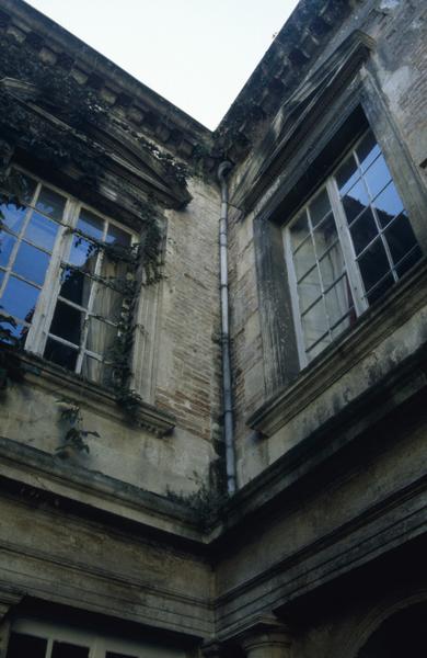 Cour intérieure : baies, murs en brique.