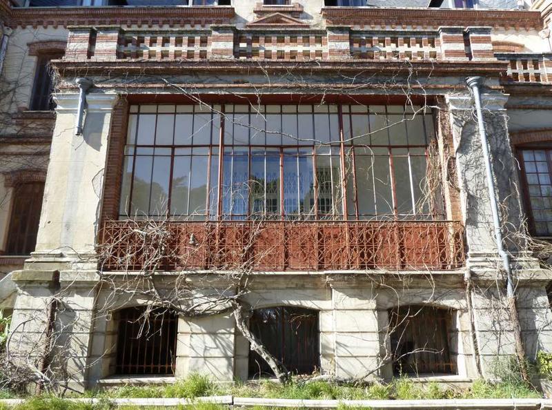 Façade sud : partie centrale formant loggia à l'origine, qui a été fermée par une véranda métallique.