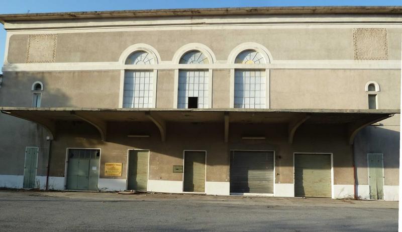 Façade avec l'auvent en béton protégeant les quais de déchargement.