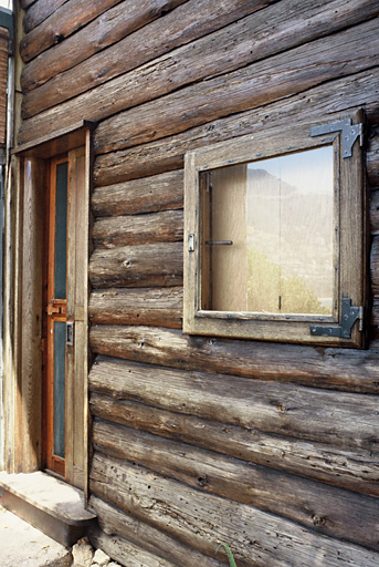 Le cabanon, détail de la façade ouest avec la porte d'entrée et une fenêtre.