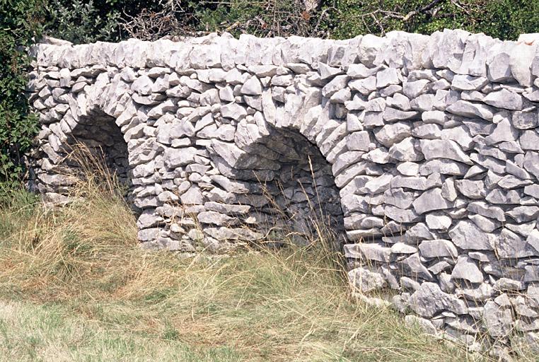 Mur de clôture avec arcades.