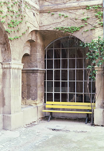 Vue du cloître depuis le jardin, détail d'une arcade à l'angle de deux galeries.