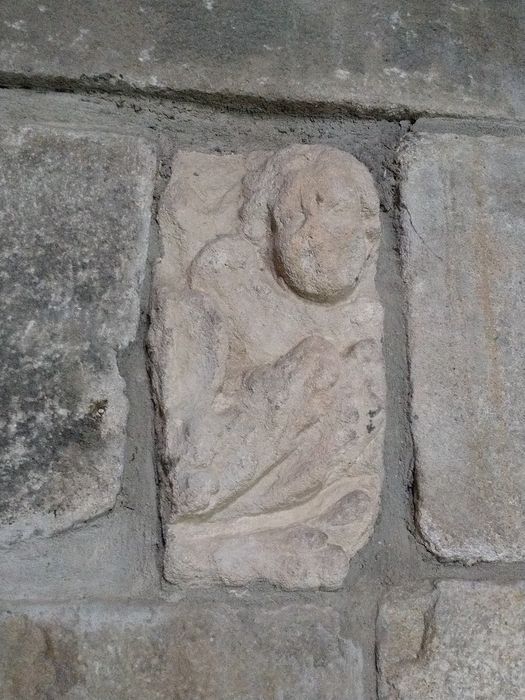 Eglise Saint-Julien de Saint-Quentin-Chaspinhac : Détail d'un fragment de pierre sculpté utilisé dans la maçonnerie